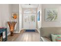 Bright and spacious entryway with hardwood floors and double doors at 8016 Willow Brook Dr, Spring Hill, FL 34606