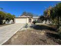 Single-story house with a light-colored exterior, landscaping, and driveway at 8177 Philatelic Dr, Spring Hill, FL 34606