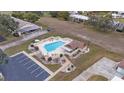 Community pool with surrounding patio furniture and landscaping at 8350 High Point Cir # 3, Port Richey, FL 34668