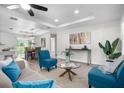 Open concept living area with teal armchairs and modern decor at 8455 Beach Rd, Spring Hill, FL 34606