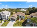 One-story house, nicely landscaped yard, and neighborhood view at 1005 Mizzen Ct, Tarpon Springs, FL 34689