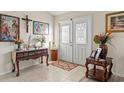 Bright entryway with decorative console table and religious artwork at 10451 Keystone St, Spring Hill, FL 34608