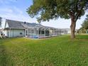 Spacious backyard with a pool and lush green grass at 1230 Venetia Dr, Spring Hill, FL 34608