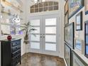 Bright entryway with double doors and art gallery wall at 12910 Oak Nut St, Hudson, FL 34667