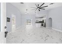 Open living area with marble floors and modern ceiling fan at 13124 Lawrence St, Spring Hill, FL 34609