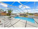 Relaxing kidney-shaped pool with a screened enclosure at 13124 Lawrence St, Spring Hill, FL 34609