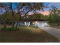 House exterior at dusk showcasing the stone facade and landscaping at 2054 Meadow Lark Rd, Spring Hill, FL 34608