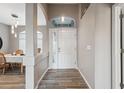 Bright entryway with tiled floors, a half wall, and a view into a dining area at 3110 Lema Dr, Spring Hill, FL 34609