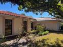 Side view showcasing the home's architecture and landscaping at 3151 Carlos Dr, Dunedin, FL 34698