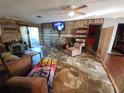 Living room with wood-paneled accent wall and tile floor at 4230 Lee Rd, Spring Hill, FL 34608