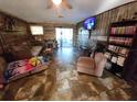 Living room with wood-paneled accent wall and tile floor at 4230 Lee Rd, Spring Hill, FL 34608