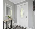 Modern entryway with a white door and a stylish console table at 4270 Paradise Cir, Hernando Beach, FL 34607