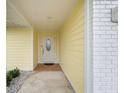 Inviting entryway with a white door and terracotta tile flooring at 4270 Paradise Cir, Hernando Beach, FL 34607
