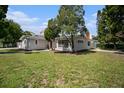 Single-story home with gray exterior, American flag, and lush lawn at 4602 W Hawthorne Rd, Tampa, FL 33611