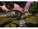 Charming one-story home with gray siding, manicured lawn, and walkway at 4602 W Hawthorne Rd, Tampa, FL 33611