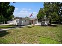 Ranch-style home with gray exterior, well-maintained lawn, and walkway at 4602 W Hawthorne Rd, Tampa, FL 33611