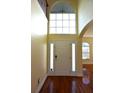 Bright entryway with hardwood floors, large windows, and a double door at 4634 Mapletree Loop, Wesley Chapel, FL 33544