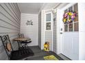 Inviting front porch with small table and chairs, perfect for relaxing at 54 Schooner Dr # 54, Palm Harbor, FL 34683