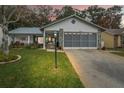 Exterior of the house at dusk, showcasing the garage and landscaping at 6453 Wedgewood Dr, Spring Hill, FL 34606