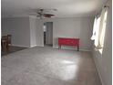 Bright living room with large window and hardwood floors at 7129 Beachdale Ct, Port Richey, FL 34668