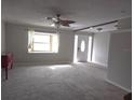 Spacious living room featuring neutral walls and carpet at 7129 Beachdale Ct, Port Richey, FL 34668