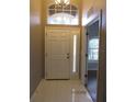 Bright entryway with tiled floor, featuring a white door and large window at 9330 Edistro Pl, New Port Richey, FL 34654