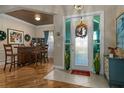 Bright and airy entryway with hardwood floors and home bar at 9398 Burnam Dr, Weeki Wachee, FL 34613