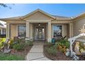 Welcoming front porch with decorative landscaping and entry door at 9398 Burnam Dr, Weeki Wachee, FL 34613