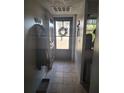 Bright entryway with tile flooring and coat hooks at 11203 Pembridge Ct # 1, Port Richey, FL 34668