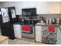 Bright kitchen features stainless steel appliances and ample counter space at 11203 Pembridge Ct # 1, Port Richey, FL 34668
