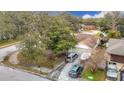 Home with driveway, boat, and surrounding trees at 12529 Shadow Ridge Blvd, Hudson, FL 34669