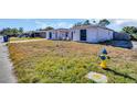 House exterior with a yard and fire hydrant at 1333 Normandy Blvd, Holiday, FL 34691