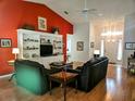 Living room with hardwood floors, fireplace, and built-in shelving at 18049 Tarrington Pl, Hudson, FL 34667
