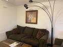 Living room with brown couch and floor lamp at 21103 Patio View Ct # 3105, Lutz, FL 33558