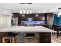Modern kitchen with large island and granite countertops at 23051 Lake Lindsey Rd, Brooksville, FL 34601