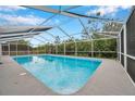 Refreshing screened-in pool area, ideal for outdoor enjoyment at 2643 Narcissus Dr, Holiday, FL 34691