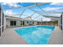 Inviting screened-in pool with a spacious deck perfect for relaxation at 2643 Narcissus Dr, Holiday, FL 34691