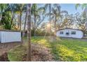 Spacious backyard with lush landscaping and shed at 405 Pine S Ave, Oldsmar, FL 34677