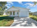 Newly built home with white siding, a front porch, and a spacious driveway at 4067 Monona Ave, Spring Hill, FL 34606