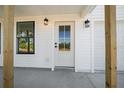Modern front door with a glass panel and black accents at 4067 Monona Ave, Spring Hill, FL 34606