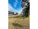 Condo building with parking lot and mature trees at 4515 Marine Pkwy # 102, New Port Richey, FL 34652