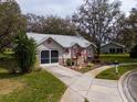 Charming single story home with grey roof and lush landscaping at 4912 Enfield Ct, New Port Richey, FL 34655