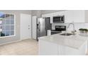 Modern kitchen featuring stainless steel appliances and white cabinets at 5948 Lyon Rd, Spring Hill, FL 34606