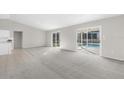 Spacious living room with sliding doors leading to the pool area at 5948 Lyon Rd, Spring Hill, FL 34606