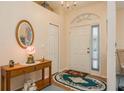 Bright entryway with a wooden console table and an oval mirror at 9639 Conservation Dr, New Port Richey, FL 34655