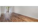 Living room featuring wood-look flooring and sliding glass doors at 1355 Powderpuff Dr # 908, Dunedin, FL 34698