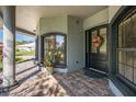 Elegant front entrance with a black door and paver walkway at 1523 Fishing Lake Dr, Odessa, FL 33556