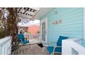 Front porch with seating and tropical plants at 1603 N Gulf N Dr # 30, Bradenton Beach, FL 34217