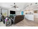 Open living area with hardwood floors, leather couches, and a teal accent wall at 3215 Rose Arbor Dr, Hernando Beach, FL 34607