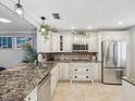 Spacious kitchen featuring granite countertops and stainless steel appliances at 3259 Hilary Cir # 1C, Palm Harbor, FL 34684